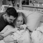 Woman and Man embracing with baby after birth