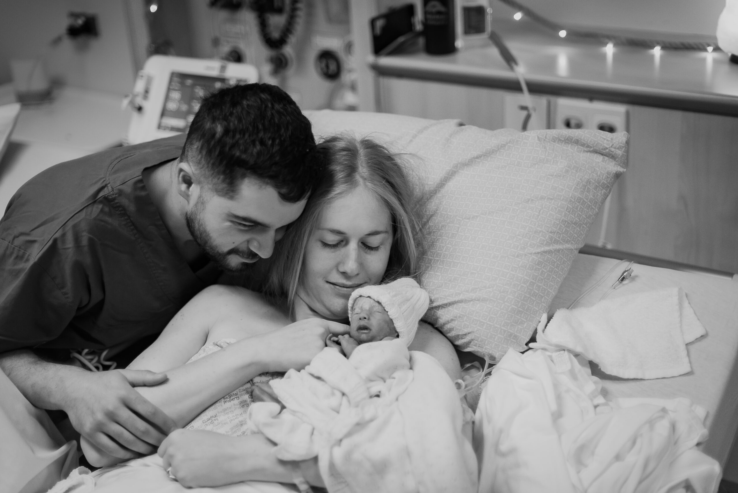 Woman and Man embracing with baby after birth