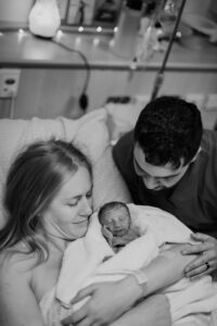 Woman and Man embracing with baby after birth